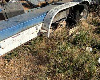 Flatbed utility trailer. Located underneath lift