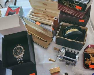Reels, watches, pens, Lighters,
