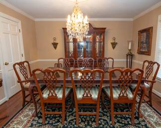 Chippendale Style Cherry Dining Table + 8 Chairs (2 Chairs are Captain Chairs) & Matching China Cabinet — Dining room TABLE Dimensions: 68 long without leaf x 83 long with one leaf x 42 1/2 wide 30 tall — CHAIR Dimensions: 22 1/2 wide at the front x 16 1/2 wide at the back x 29 1/2 wide back at the top x 39 tall in the back x 29 1/2 tall to seat — Dining room CHINA CABINET Dimensions: 86 1/4 tall x 64 wide x 18 1/2 deep x Top 16 deep