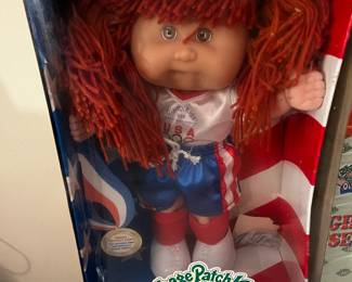 #304	cabbage patch doll olymikids red head pig tails shorts and shirt	 $20.00 			
