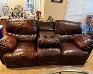 #25	double recliner brown leather sofa with middle cup holder 89 long as finish 	 $325.00 			
