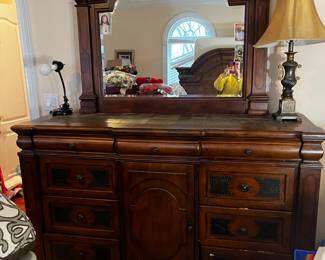#3	Ashley dresser with 12 drawers, bevel mirror leather design on drawer stone top68Wx19Dx44T mirror 50x41	 $275.00 			
