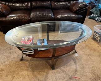 #26	oval glass top coffee table with metal legs and shelf 48x28x20	 $65.00 			
