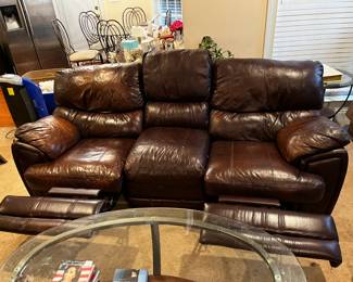 #25	double recliner brown leather sofa with middle cup holder 89 long as finish 	 $325.00 			
