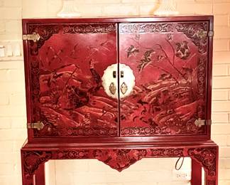 Chinese carved red lacquer cabinet on stand