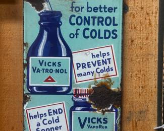 This is a vintage porcelain sign advertising Vicks cold remedies. The sign features a red and white header that says "COME IN". Below that, the sign is light blue and features images of Vicks Va-Tro-Nol and Vicks VapoRub bottles. Text on the sign reads "for better CONTROL of COLDS," "helps PREVENT many Colds," and "helps END a Cold Sooner." The sign is rectangular and shows signs of wear and rust, indicative of its age and exposure to the elements. The presence of these products on the sign suggests it dates back to a period when these remedies were heavily marketed for cold prevention and treatment.