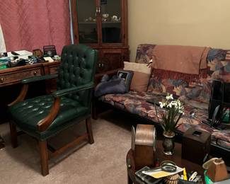 Green Leather armchair, Tropical print futon, corner display cabinets, leather top carved wooden desk