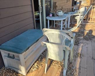Outdoor deck storage unit, table and chairs and other misc outdoor items.