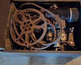 Antique movie projector and supplies