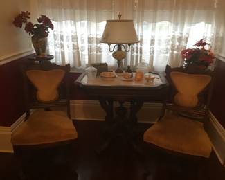 Two chairs of the parlor set, marble top Victorian  table with removable rim,  one of several pedestals, lamp