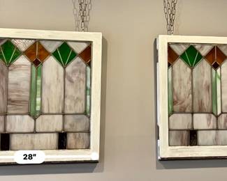 Two matching vintage stained glass windows.
27” x 28” - Wood frame painted white on one side and natural wood on the other.  Window on the right has three cracked pieces of glass