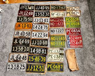 Great selection of vintage Michigan license plates, some with their original paper envelopes 