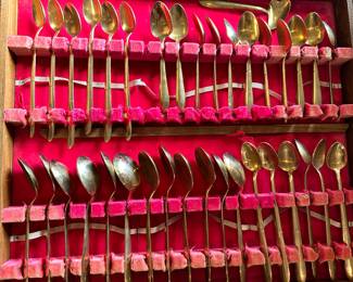 #106 - $150 - Bangkok Thailand Gold color flatware - 12 tea spoons - 12 soup spoons - 12 dinner spoons - 1 oyster spoon - 12 dinner knives - 12 butter knives - 12 - caviar spoons - 12 small knives - 10 serving utensils