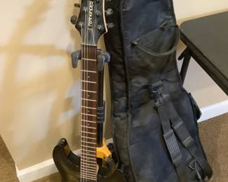 Fernanda’s six string guitar and case plus stand