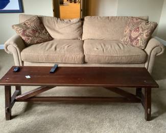 Tan sofa and antique bench/coffee table