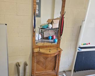 Tall wooden hall tree with a mirror, hooks for hanging hats or whatever and a shelf below for putting shoes. $60