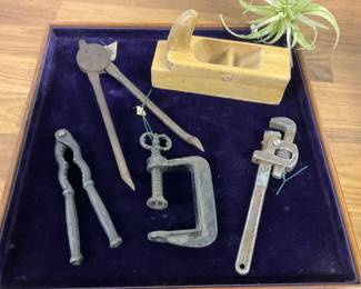 Vintage hand tools and carved wooden planer replica. 
