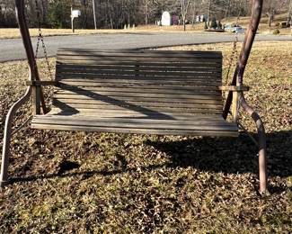 Wooden porch swing in hanger 