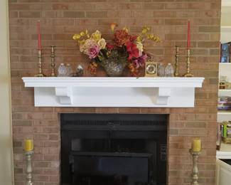 Brass candlesticks, boxes of candles of various sizes, florals, clocks