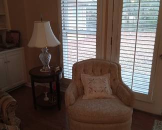 There is a pair of tufted chairs