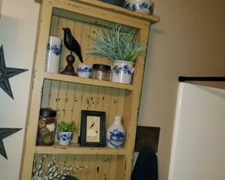 More small Rowe Pottery and mustard painted wall shelf