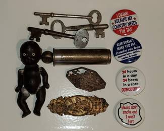 Bisque doll, pinback buttons, old keys