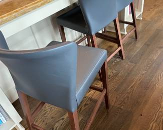 $390 Three Curran counter height leather stools.  19"w x 20"x 36"h at the back.  24" seat height. As found on the legs per normal use. Available for online purchase which opens Wednesday at 7pm.  See sale description to learn how to buy online. 