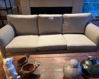 $360. Roll arm three cushion custom sofa in linen colored upholstery.  91"w x 36"d x 37"h.  One as found issues in next photo.  Available for online purchase which opens Wednesday at 7pm.  See sale description to learn how to buy online. 
