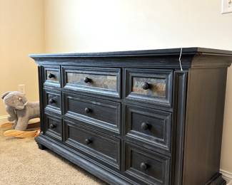 C13 - $150. "Soho Baby" Stone Hill 9 drawer Dresser Smoke Gray - 2017.  Dresser measures 60" wide x 20" deep x 34" tall. One knob needs some glue - all drawers slide easily with soft close drawers. Top has some flaking paint - see photos.  