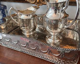 Silver plate pitchers on tray