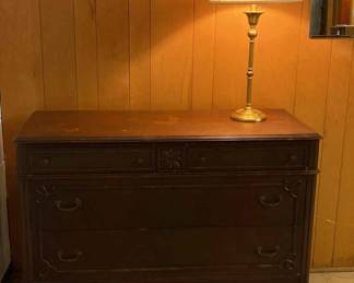 Wood Dresser With Wheels And Brass Colored Lamp
