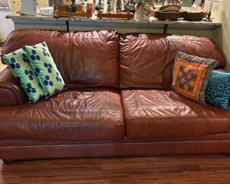 Well loved leather 2 cushion sofa (91"w x 42"d):  $300.00