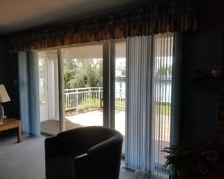 Large sliding glass door with fixed panels; vertical blinds