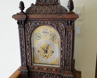 Carved Mahogany Quarter Chime Clock with Squirrel and Acorn decor has its key.