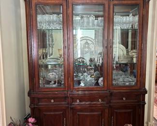 Hooker Furniture Cabinet.  Stunning Mahogany China cabinet with 3 drawers and 3 doors for storage.  One drawer is silver drawer.  Beveled glass doors and mirror back
