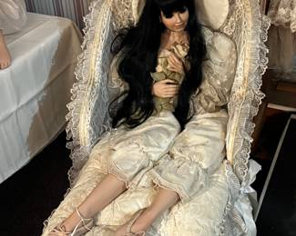 Large collectable doll with Wicker Lounge chair