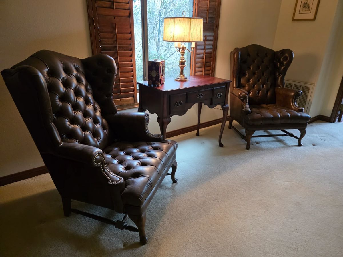 Leather Chesterfield style wing back chairs. A pair. Butler entry table