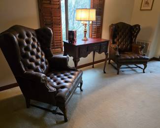 Leather Chesterfield style wing back chairs. A pair. Butler entry table