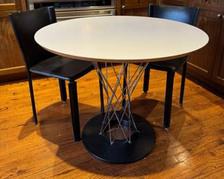 Noguchi Cyclone Dining Table & Mario Bellini Black Leather Chairs. Measures 36" D x 29" H. Photo 1 of 4.