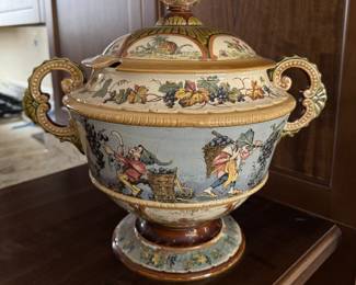 Covered Tureen Marked "Geschutzt 2339" And "1028". Polychrome Transfer Decoration Of Elves Producing Wine For Bacchus. Measures 17" W x 16" H. Photo 1 of 5.