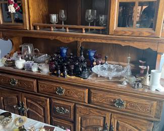 This china cabinet is only $150! On it is shown Avon Ruby glass, collectible plates and glass sets.  In foreground on dining table are several Avon perfumes both miniatures and full sized from 1950's - 1970's & 80's!
