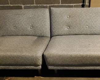 MCM pair of loveseats in original grey speckled vinyl. Each need reupolstered. With great bones.