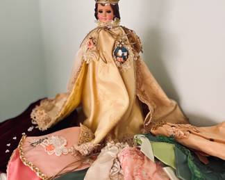 Infant of Prague and selection of ornate handmade vestments