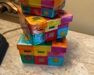 These boxes are made from some kind of shell and hand painted. 