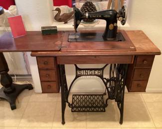 Vintage Singer sewing machine in cabinet
