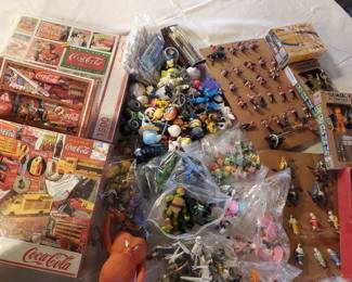 some misc things new coke puzzles and vintage action figures including some star wars and ninja turtles and some others that are note unpacked yet