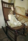 Late 1800's solid dark oak rocker, caned seat and back