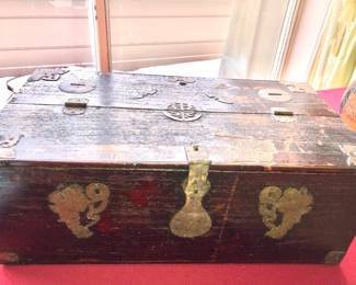 Chinese treasure box with coin inserts on top, not a high-quality item, rather thin wood