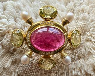 A finely made estate peridot, pearl and rubellite pin set an 18 karat gold.