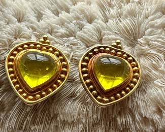A pair of 18k peridot heart shaped omega back earrings by Denise roberge.